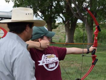 Youth participate in shooting sports activities.