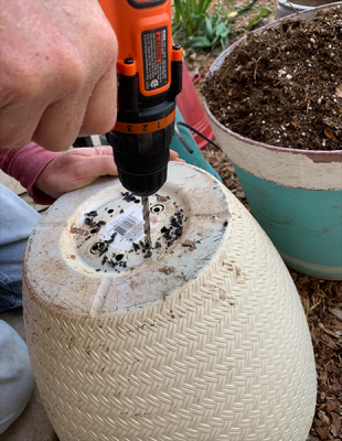 Image of person drilling holes on a planter