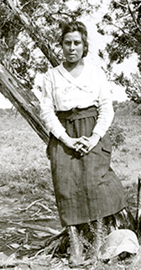 Fabiola as a young woman leaning on a tree.